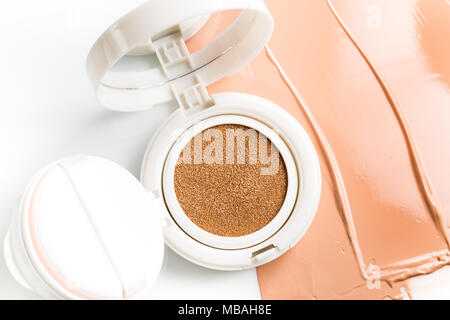 Foundation cushion with sponge and puff on white background. Stock Photo