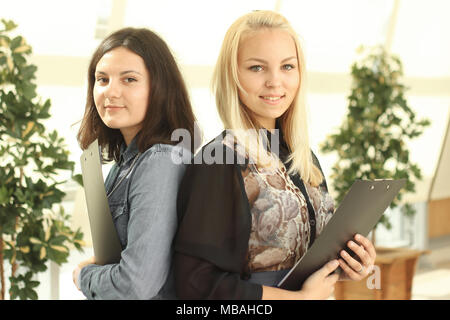 close up.two female employees with a clipboard standing in the office Stock Photo