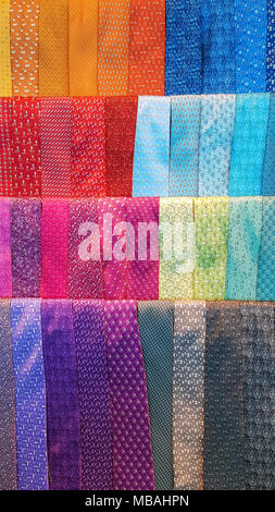 Display of colorful men's dress neckties. Vibrant colors and textures. Stock Photo