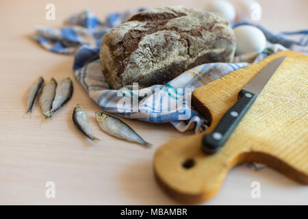 Rural breakfast with black bread, fish and eggs Stock Photo