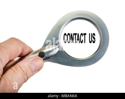 Magnifying glass in the hand on the white. Concact us concept. Stock Photo