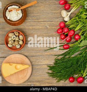 Healthy food (vegetables, cheese, egg, sour cream) on old wooden table. Top view. Stock Photo