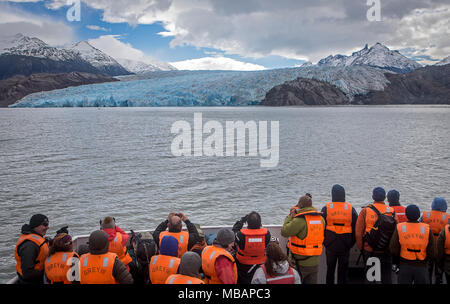 Grey Glacier and Hikers in a Catamaran, crossing Grey lake between Refugio Grey and Hotel Lago Grey, Torres del Paine national park, Patagonia, Chile Stock Photo