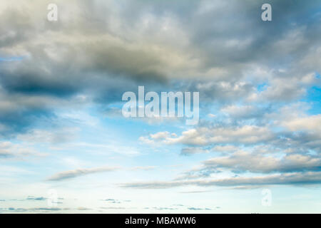 Sky panorama with colorful clouds, mainly tones of blue, and lines of light. Stock Photo