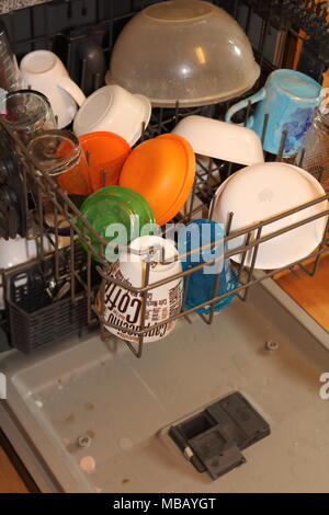 Dirty dishes loaded in a dish washer Stock Photo