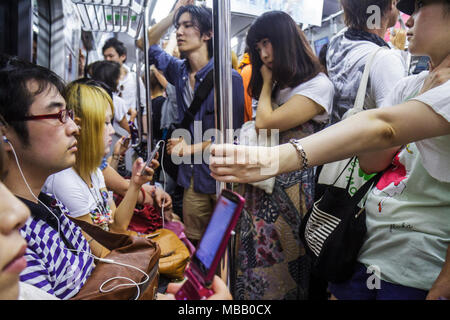Tokyo Japan,Asia,Orient,Shinagawa Station,JR Yamanote Line,commuters,riders,Asian Asians ethnic immigrant immigrants minority,Oriental,man men male ad Stock Photo
