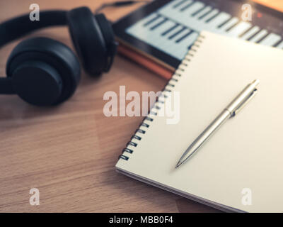 Music Creation Tools, Headphone, Notebook, Electronic Tablet and Pen on Wooden Background Stock Photo