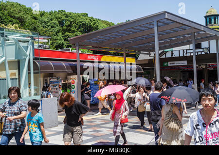 Tokyo Japan,Harajuku,JR Harajuku Station,Asian Oriental,man men male adult adults,woman female women,Muslim,umbrella,Japanese,Oriental,Japan110710059 Stock Photo