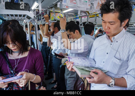 Tokyo Japan,Yurakucho,JR Yurakucho Station,Yamanote Line,Asian Oriental,man men male adult adults,woman female women,crowded,standing,commuters,train Stock Photo