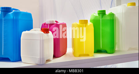 Empty colorful plastic cans for liquids in the store Stock Photo