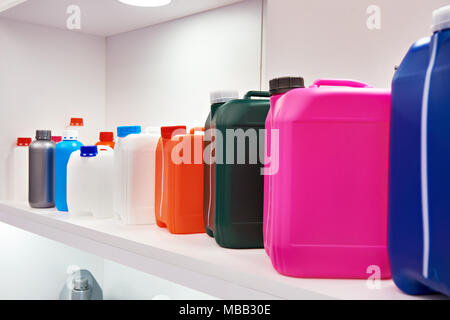 Empty colorful plastic cans for liquids in the store Stock Photo