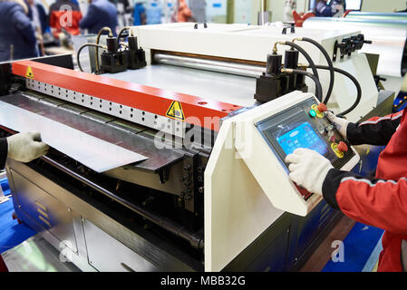Operators of the machine for cutting sheet metal Stock Photo