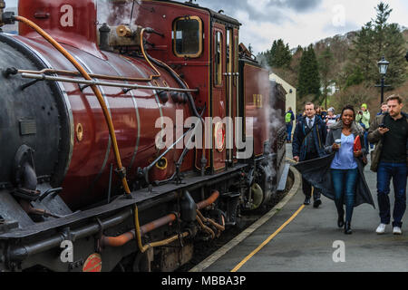 A Welsh Highland Railway narrow gauge steam train calls at Beddgelert station, Snowdonia,  Gwynedd, Wales, UK. April 2018. Stock Photo