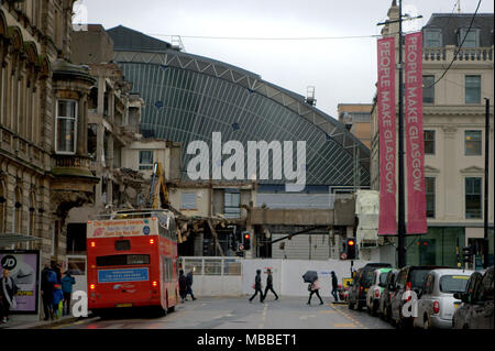 Glasgow, Scotland, UK 10th April. UK Weather :George square  tourist sightseeing bus queen street station refurbishment Victorian railway station train shed facade revealed  Miserable wet day with squalid showers for locals and tourists in the city centre. Gerard Ferry/Alamy news Stock Photo