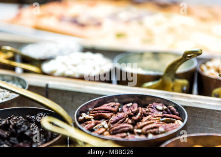 Macro closeup of wooden tray with bowls of dried fruit, nuts in kitchen counter cooking measurement portions sweet Stock Photo