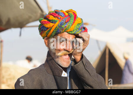 Elderly man with a moustache and a colourful turban at the Pushkar Camel Fair, Pushkar, Rajasthan, India, Stock Photo