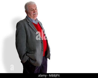 Forgetful elderly man standing thinking trying to remember something or confused due to senility or Alzheimers disease over white with copy space Stock Photo