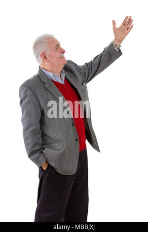 Senior grey-haired man raising his left arm showing something with a smile in a side profile view isolated on white Stock Photo