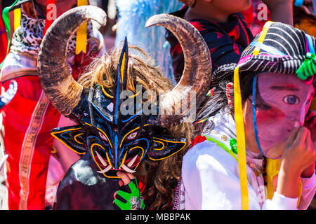 Píllaro, ECUADOR - FEBRUARY 6, 2016: Unknown locals dressed up participating in the Diablada, popular town celebrations with people dressed as devils  Stock Photo