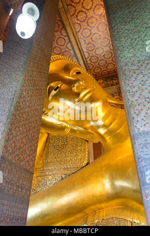 BANGKOK, THAILAND - DECEMBER 29, 2012: Golden reclining buddha in Wat Pho temple. Stock Photo