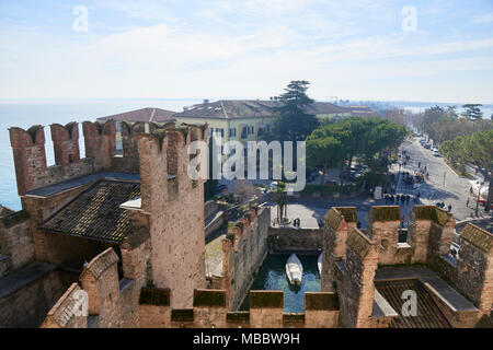 Sirmione, Italy - February 21, 2016: The Scaliger Castle is a medieval port fortification located at the entrance to the sirmio peninsula which divide Stock Photo