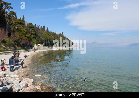 Sirmione, Italy - February 21, 2016: Landscape of the coast of Sirmione peninsula which divides the lower part of Lake Garda. It is a famous vacation  Stock Photo