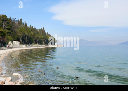 Sirmione, Italy - February 21, 2016: Landscape of the coast of Sirmione peninsula which divides the lower part of Lake Garda. It is a famous vacation  Stock Photo