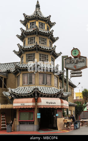 Los Angeles, CA, USA - April 5, 2018: Pagoda of HopLouie bar in cental Chinatown against silver sky. Carpenter working on the side. Stock Photo