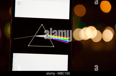 Pink Floyd's Dark Side of the Moon disc on a mobile phone with defocused Bokeh effect background on March 13, 2018 in Madrid, Spain. Stock Photo