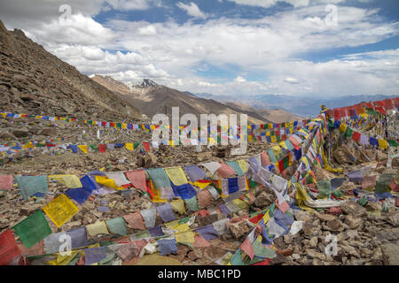 Radiating from a one point, colorful patches are inscribed with prayers to blow in the wind.  Taken at Khardung-la, 'highest motorable road in world' Stock Photo