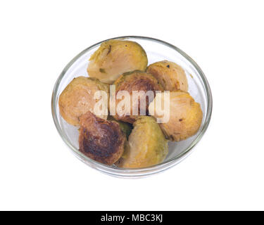 Roasted brussels sprouts in clear glass dish isolated on white background Stock Photo