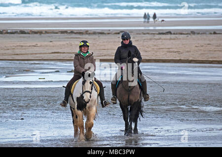 riding horses on perranporth beach cornwall, england, britain, uk. Stock Photo