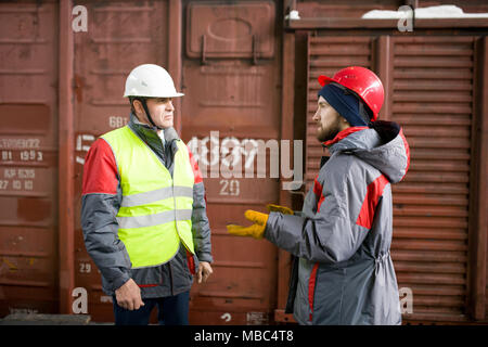 Worker Talking to Supervisor in Docks Stock Photo