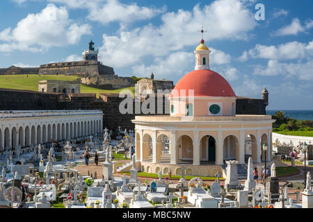 El Morro Fort stands guard over historic Santa Maria Magdalena de Pazzis Cemetery in old San Juan Puerto Rico Stock Photo