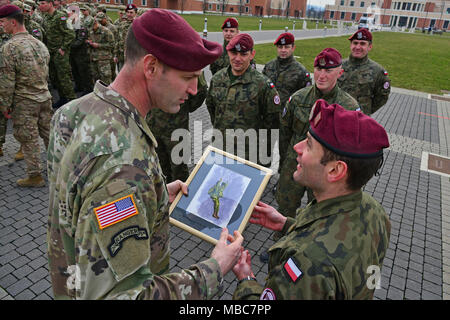 U.S. Army Col. James Bartholomees III, Commander of the 173rd Airborne Brigade, receives a gift from a Poland Army Soldier during the Expert Infantryman Badge (EIB) ceremony at Caserma Del Din, Vicenza, Italy, 15 Feb. 2018. (U.S. Army Stock Photo