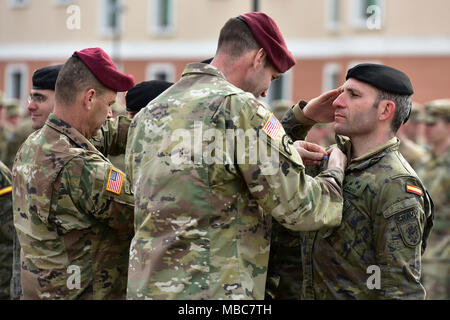 Col. James B. Bartholomees III, Commander of the 173rd Airborne Brigade (right) and Command Sgt. Maj. Franklin Velez of the 173rd Airborne Brigade (left), pin Expert Infantryman Badge’s (EIB) on Spanish Army Soldiers during Expert Infantryman Badge (EIB) ceremony at Caserma Del Din, Vicenza, Italy, 15 Feb. 2018. (U.S. Army Stock Photo