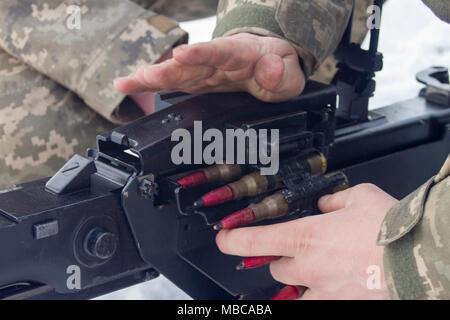 Ukrainian Soldiers assigned to 3rd Battalion, 14th Mechanized Brigade load ammunition into a DshK machine gun at the Yavoriv Combat Training Center here Feb. 16. Currently the 3-14th is completing a training rotation at the CTC where they will be mentored by U.S., Canadian, Lithuanian, Polish, and U.K service members as they strive toward attaining their goal of achieving NATO interoperability. (U.S. Army Stock Photo
