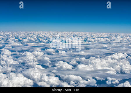 Flying over fluffy white cumulo-nimbus clouds, Australia Stock Photo