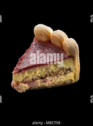 slice of festive raspberry cake with biscuits Stock Photo