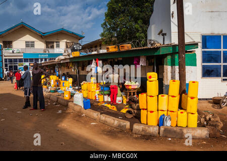 MAKENI, SIERRA LEONE - June 06, 2013: West Africa, group of unknown people along Makeni's main road with yellow tanks and fuel, Sierra Leone Stock Photo