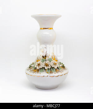 White ceramic porcelain rich decorated vase with roses and gold pattern isolated on white background Stock Photo