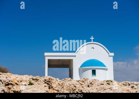 Small Greek white chapel with a blue roof. Agioi Anargyroi chapel, Cyprus Stock Photo