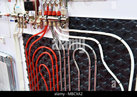 Plastic pipes of water heating system in house Stock Photo