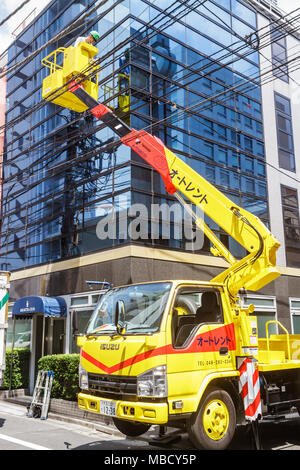 Tokyo Japan,Ryogoku,kanji,Japanese English,Isuzu,cherry picker bucket truck,lifter,telescoping,under new construction site building builder,worker,wor Stock Photo