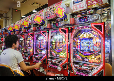 Tokyo Japan,Ryogoku,kanji,pachinko parlor,gamble,gambling,prizes,vertical pinball machine,Asian Oriental,man men male adult adults,playing,Japanese,Or Stock Photo