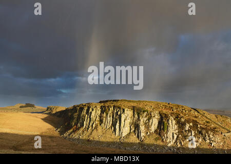 Hadrian's Wall on a stormy day in winter, looking across Peel Gap, close to the Steel Rigg car park, towards Peel Crags and on towards Crag Lough Stock Photo