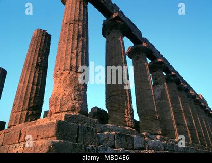Greek Mythology. Temple of Juno. The Temple of Hera Lacinia, or Juno, at Agrigento, Sicily, built circa 440 BC. The shot has been taken to show how the first rays of sunrise (in August) strike the east end of the temple. Stock Photo