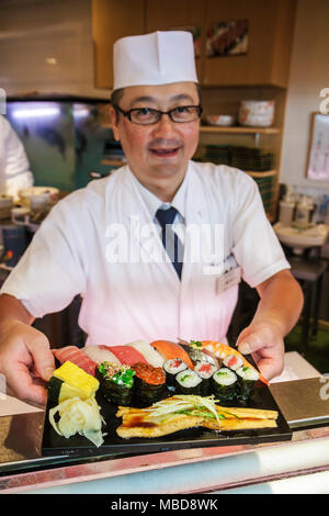 Tokyo Japan,Ueno,Chuo Dori,kanji,Japanese English,characters,symbols,sushi bar,restaurant restaurants food dining cafe cafes,chef,serving,service,fish Stock Photo