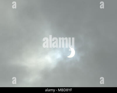Partial eclipse of the sun viewed through clouds in Brest, at about 10.30 am, on March 20, 2015 Stock Photo