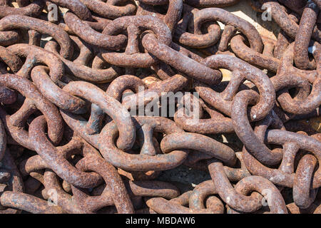 Rusty anchor chain links in a harbor. Greece. Stock Photo